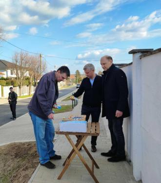 Szász József alpolgármester és Szatmáry Kristóf országgyűlési képviselő frissítővel kínálják a lakost