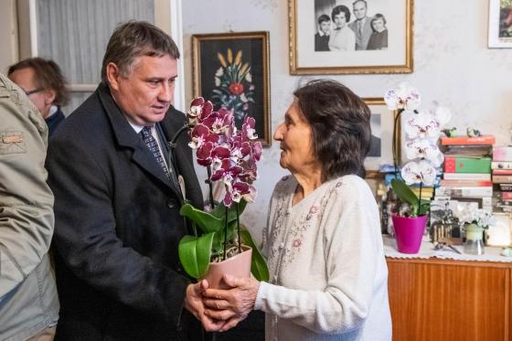 Kovács Péter polgármester köszönti Bányai Istvánnét virággal